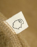 One-piece i merinoullfleece til baby Ørkengress