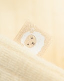 One-piece u/føtter i merinoull til baby Eggedosis
